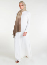 Long Line Abaya in Classic White, featuring a flattering silhouette that effortlessly complements your style. Experience comfort and sophistication in every step with this must-have addition to your modest collection.