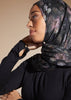 Black colour. Cut in 100% cotton jersey with a fitted bodice & voluminous drop. Styling details include a round neckline with subtle pleats. Features button fastenings on the back & sleeve cuffs. 