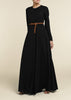 Black colour. Cut in 100% cotton jersey with a fitted bodice & voluminous drop. Styling details include a round neckline with subtle pleats. Features button fastenings on the back & sleeve cuffs. 