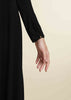 Black colour. Cut in 100% cotton jersey with a fitted bodice & voluminous drop. Styling details include a round neckline with subtle pleats. Features button fastenings on the back & sleeve cuffs. 