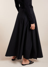 Constructed with premium quality natural cotton, this expertly crafted skirt boasts a half moon cut and a pristine high waistband. The discreet size zipper and button opening add a touch of functionality to this versatile piece. Classic black colour. 