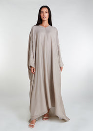Ideal for summer events and trips abroad, this kaftan is light and airy, providing a cool and understated look. With its oversized design and slightly raised front, it is both lightweight and breezy. The neutral color is flattering for all body types. Neutral hue.