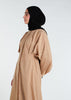 This Maxi Shirt Dress Sand features cuffed sleeves and pockets, giving the appearance of a tucked-in shirt and skirt when it is actually a one-piece outfit. Pleats at the waist create a cinch, while the top half remains loose for a comfortable fit. The dress is cut in an A-line style. Neutral beige tone.