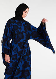 Elevate your evening and garden party attire with the striking Midnight Rose Kaftan, featuring a bold black and blue rose print. Designed with fully lined, dramatic pointed wide sleeves, this kaftan is perfect for special occasions. 
