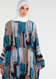 This print Kaftan boasts a full lining, side slits for ease of movement, and a free-flowing design that is ideal for the summer season. For a snugger fit, choose a size down as the Kaftan is designed to be loose-fitting. Paint brush splashes in multicolour, vertical.